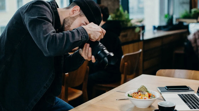 a guy taking picture of food